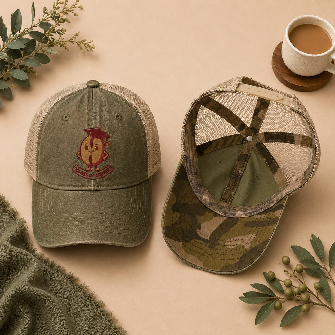 Two green baseball caps with different designs on a beige surface with coffee and leaves.