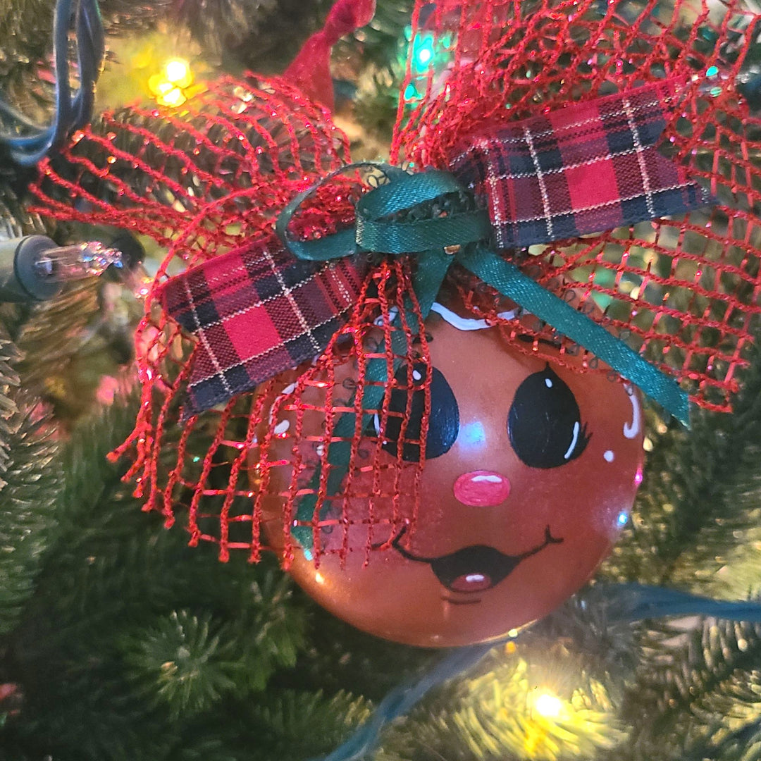 Decorative Christmas ornament with a face on a tree